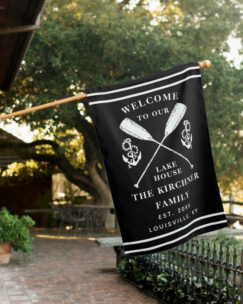 Black welcome flag with white lettering and crossed oars.