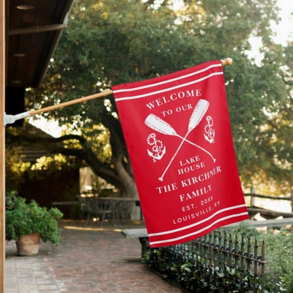 Red Welcome Flag With Crossed Oars, Anchors, And The Kirchner Family Name.