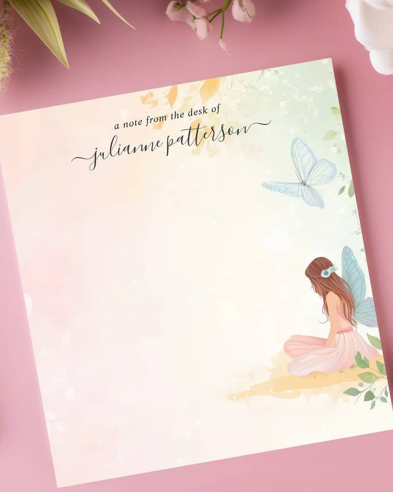 Personalized stationery featuring a seated fairy with butterfly wings and a butterfly, on a soft watercolor background.