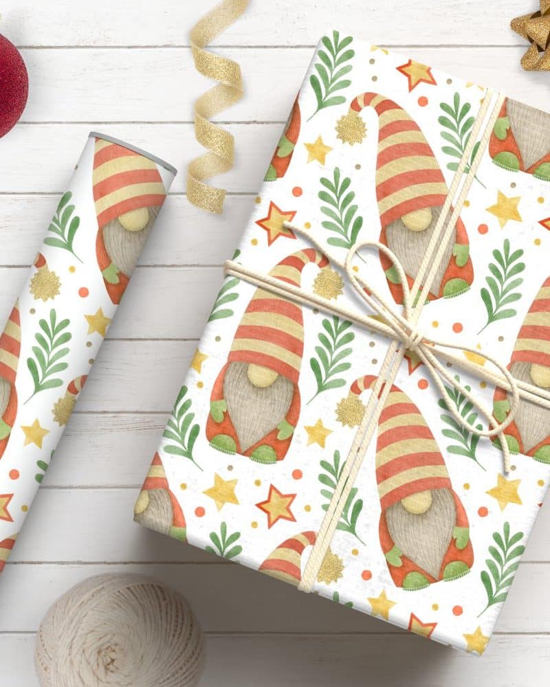 A wrapped gift and a roll of wrapping paper, both featuring a repeating pattern of Christmas gnomes.