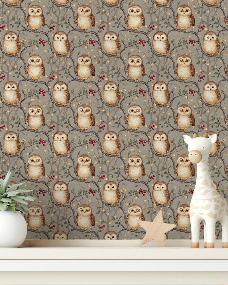 A shelf displays a taupe owl-themed wallpaper featuring numerous owls perched on branches with berries. A small wooden giraffe and star are also on the shelf.