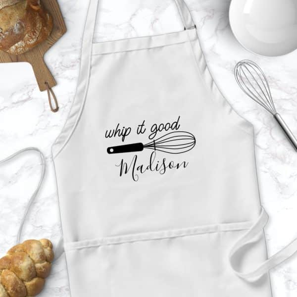 White Apron With The Text Whip It Good And Madison, Along With A Whisk Graphic.
