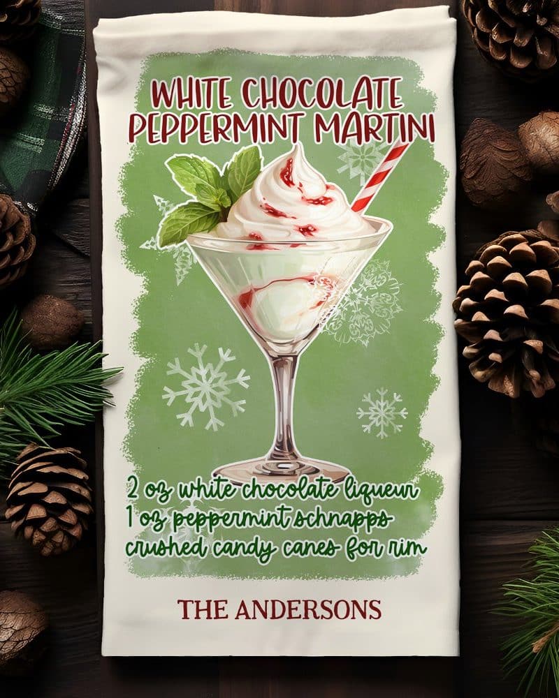 A kitchen towel depicting a white chocolate peppermint martini garnished with whipped cream and a candy cane.