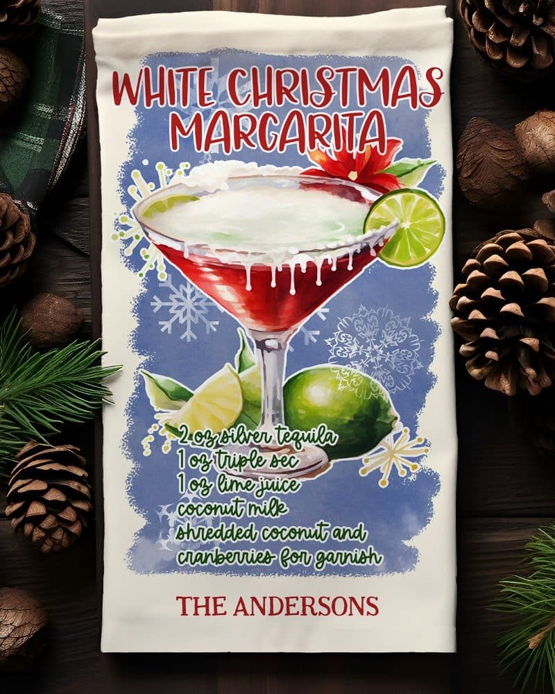 Kitchen towel with watercolor illustration of a White Christmas Margarita cocktail recipe and The Andersons name.