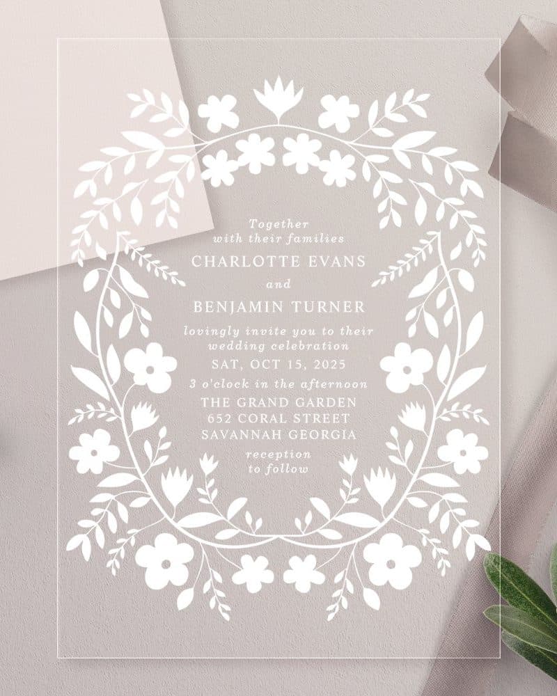 Clear acrylic wedding invitation with floral border, announcing Charlotte Evans and Benjamin Turner's October 15th wedding.