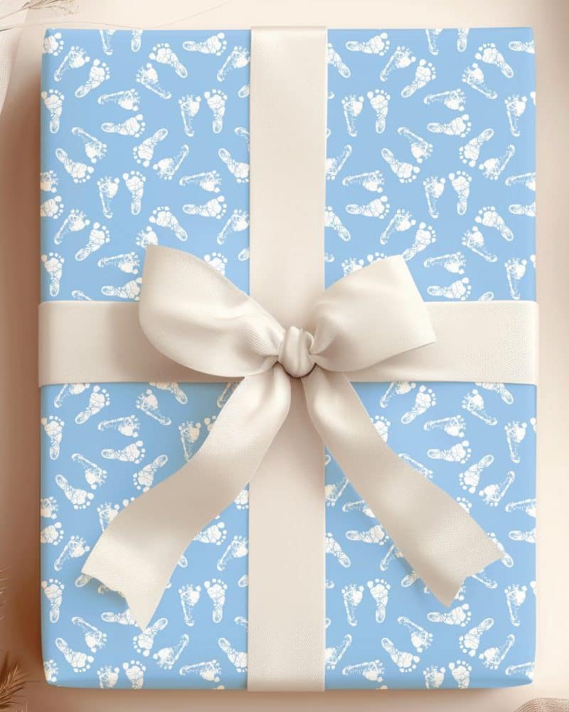 Light blue gift box with white baby footprints and a cream-colored ribbon.