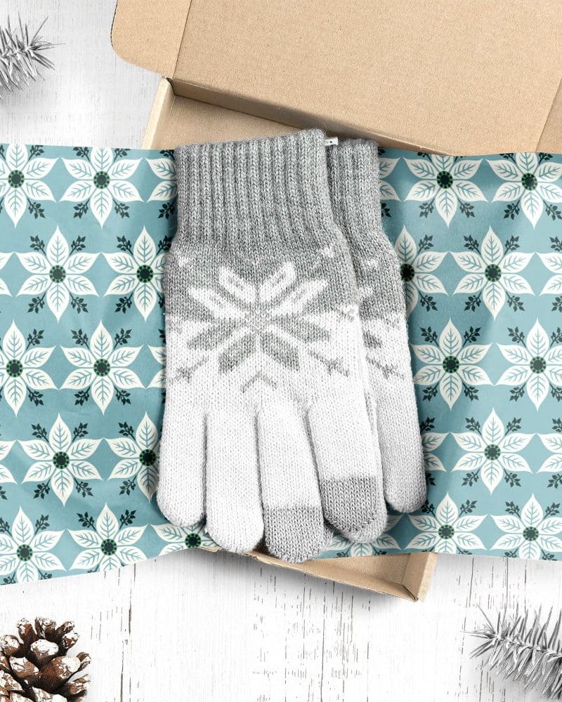 Pair of grey and white snowflake patterned gloves in a gift box.