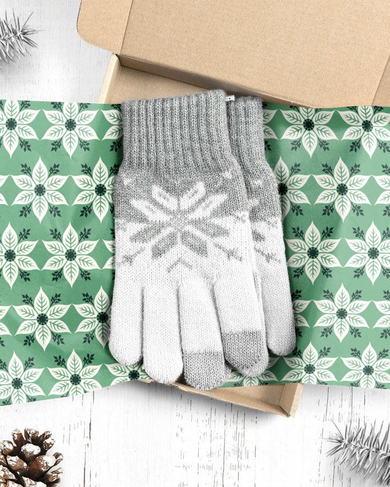 Pair of gray and white snowflake patterned gloves in a gift box.