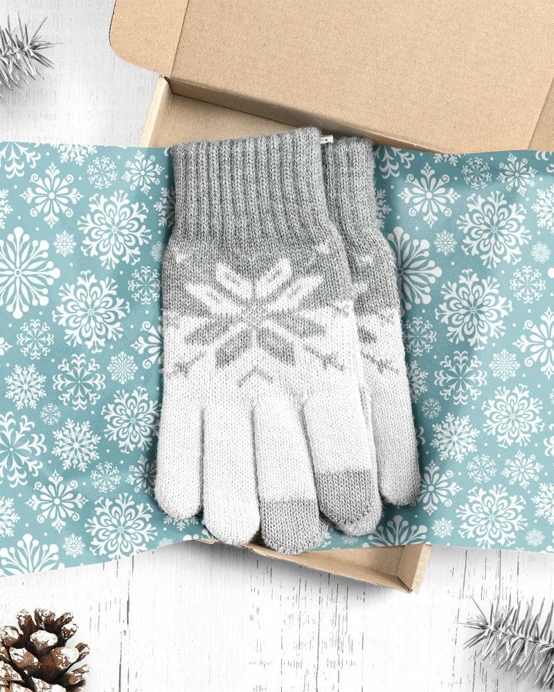 Pair of grey and white snowflake patterned gloves in a gift box.