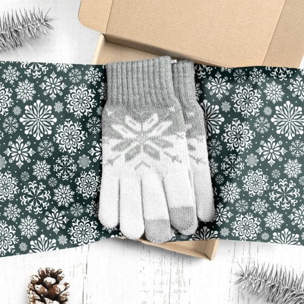 A Pair Of Gray And White Snowflake Patterned Gloves In A Gift Box.