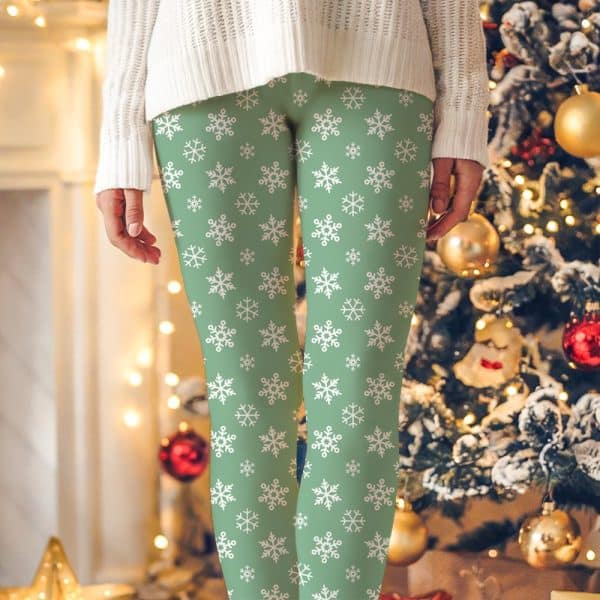 Sage Green Leggings With A White Snowflake Pattern.