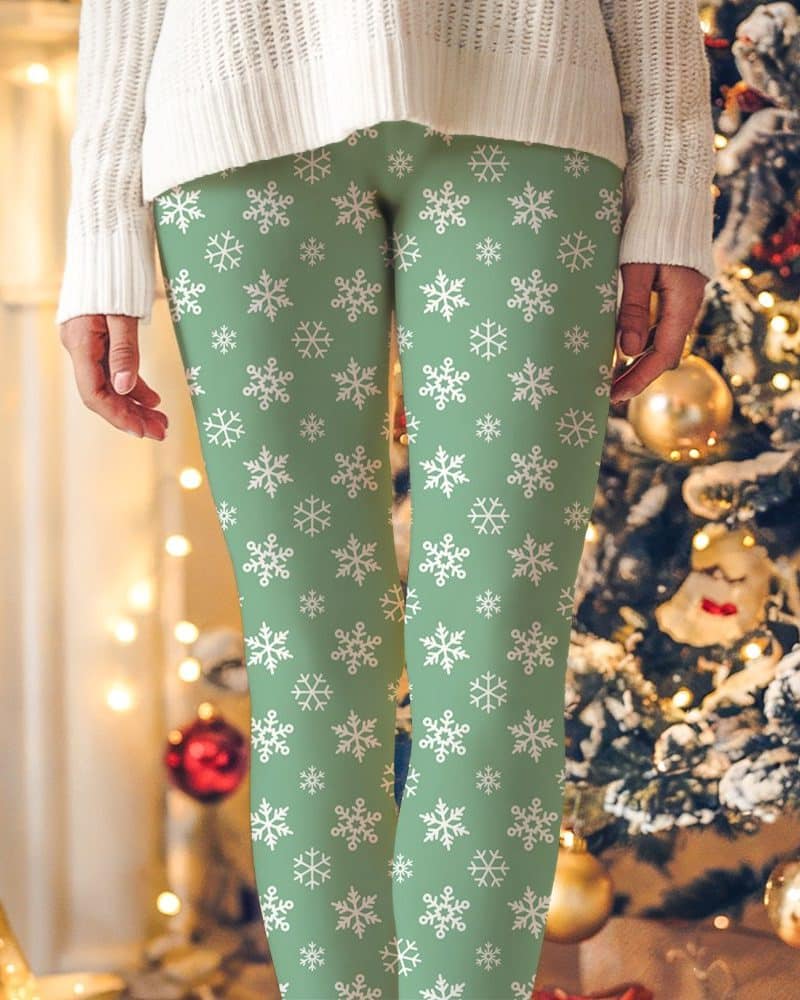 Sage green leggings with a white snowflake pattern.
