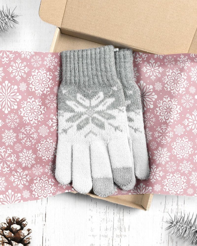 Pair of grey and white snowflake patterned gloves in a gift box.