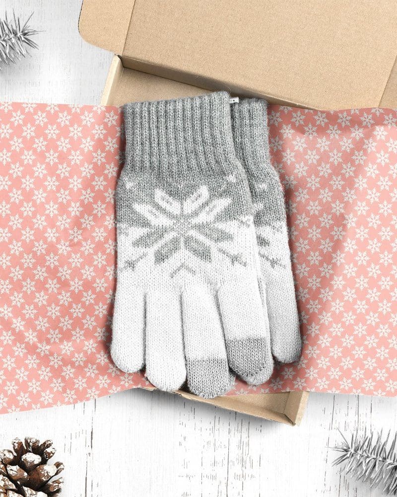 Pair of gray and white snowflake patterned gloves in a gift box.
