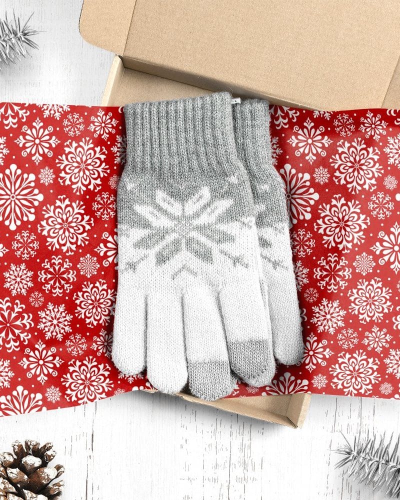 Gray and white snowflake patterned gloves in a Christmas-themed gift box.
