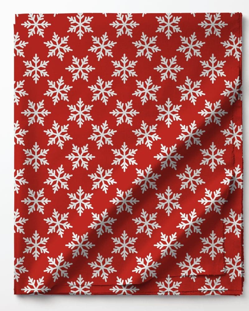 Red fabric with a repeating pattern of white snowflakes.