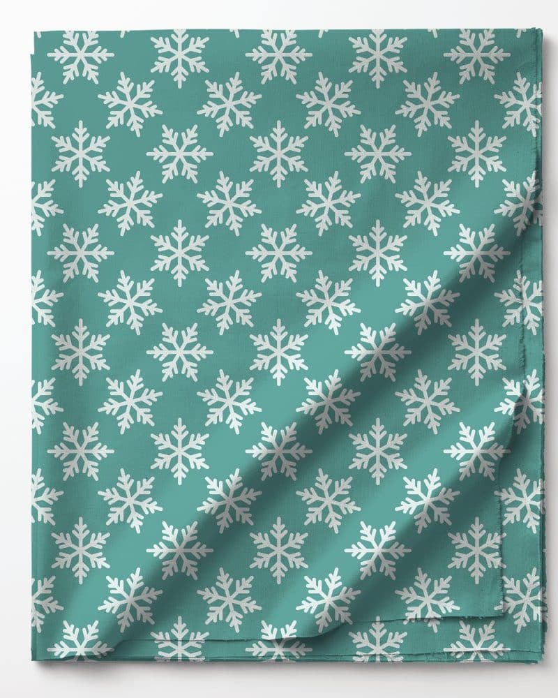 Teal fabric with a repeating pattern of white snowflakes.