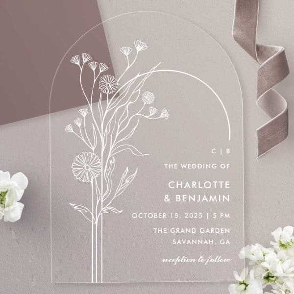 Arch-Shaped Clear Acrylic Wedding Invitation With A Minimalist Floral Design And Wedding Details.