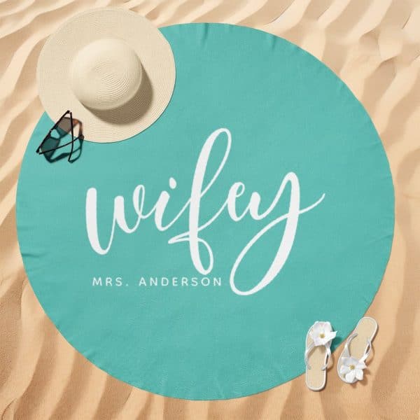 Teal Round Beach Towel With The Word Wifey And Mrs. Anderson In White Script.