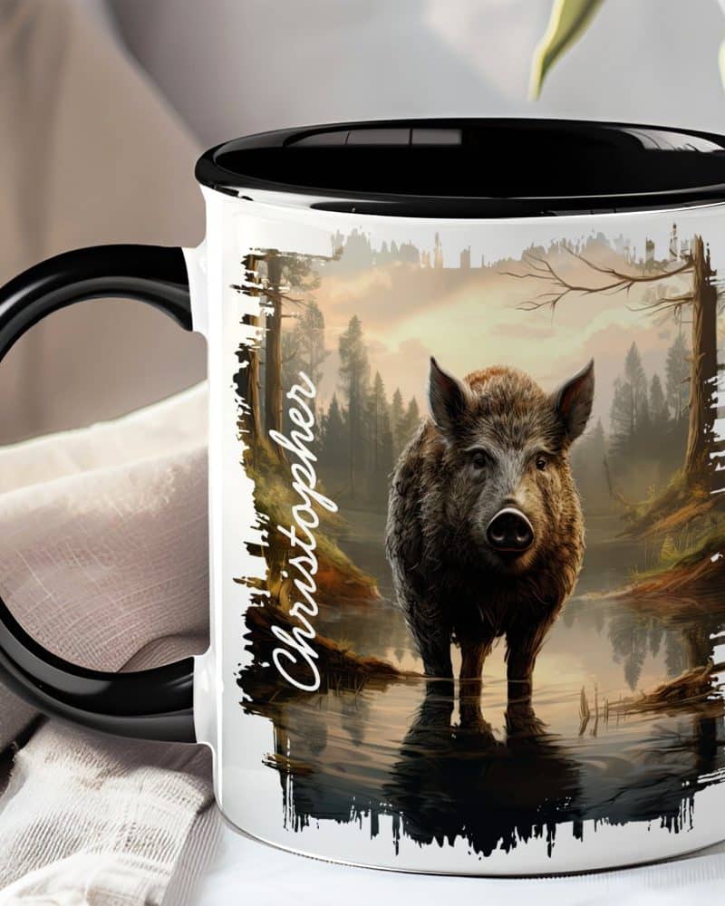 White coffee mug with black handle and interior, featuring a boar in a forest reflecting in water. The name Christopher is printed on the side.