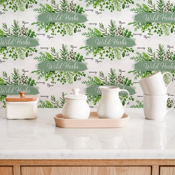 White Kitchenware Sits On A Counter With A Backdrop Featuring A Repeating Pattern Of Watercolor Wild Herbs And Their Names.