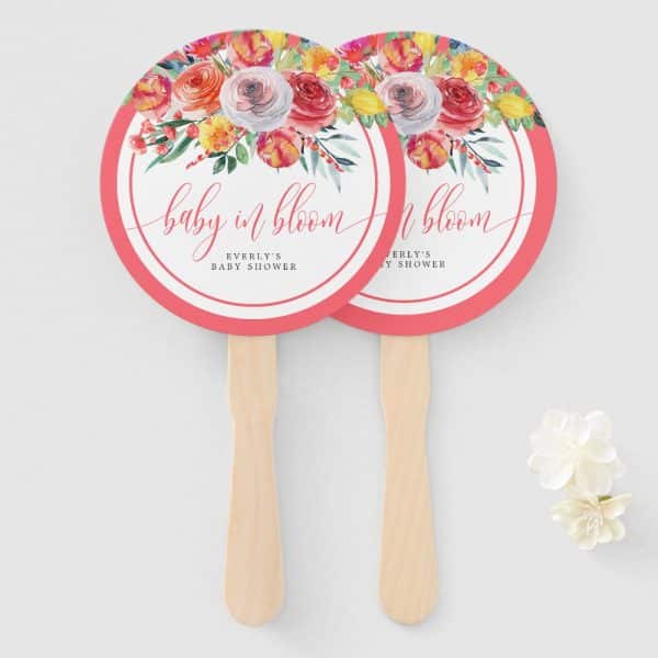 Two Coral Pink Baby Shower Hand Fans With Watercolor Floral Designs And The Text Baby In Bloom.
