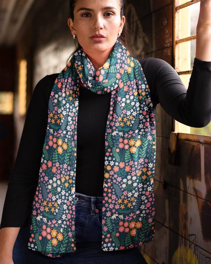 Woman wearing a teal floral patterned scarf.