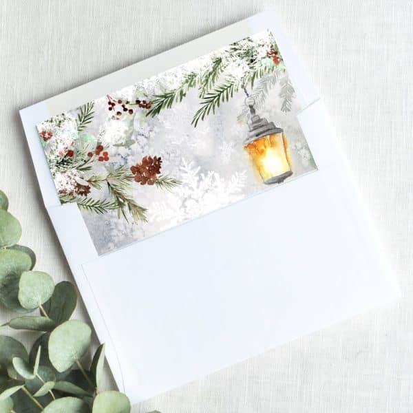 A Winter Holiday Card With A Watercolor Design Of A Lantern, Pine Branches, And Snowflakes.