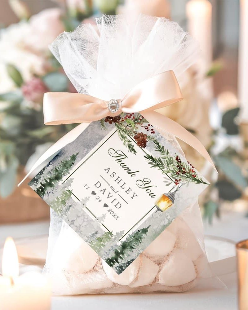 Wedding favor bag with a wintery design, containing white candies and a thank you tag with the couple's names and wedding date.
