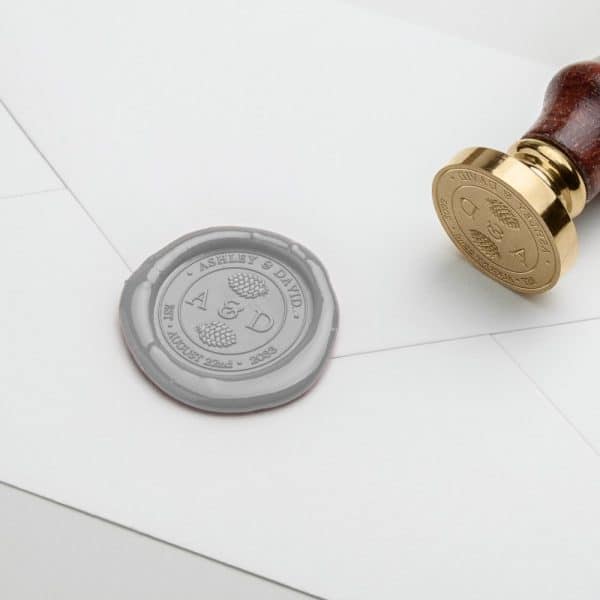 Gray Wax Seal On A White Envelope With The Initials A &Amp; D, Ashley &Amp; David, And Wedding Date.