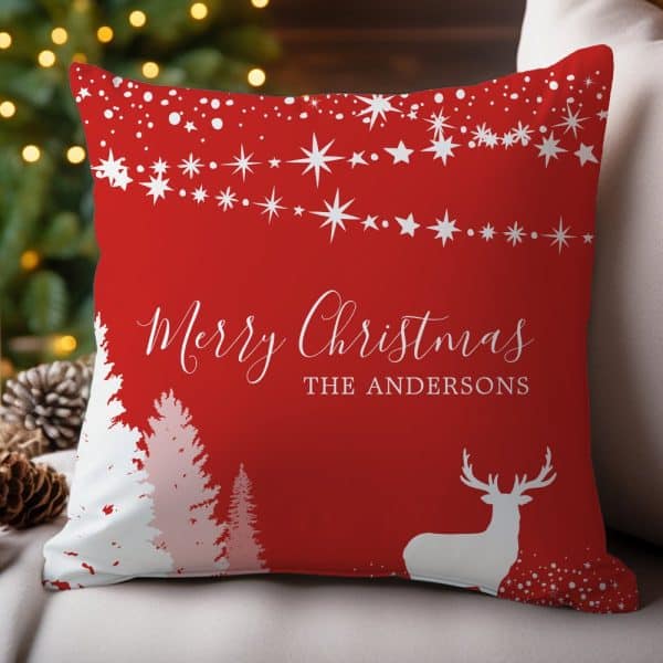 Red Christmas Throw Pillow With White Stars, Trees, Reindeer, And Personalized Text.