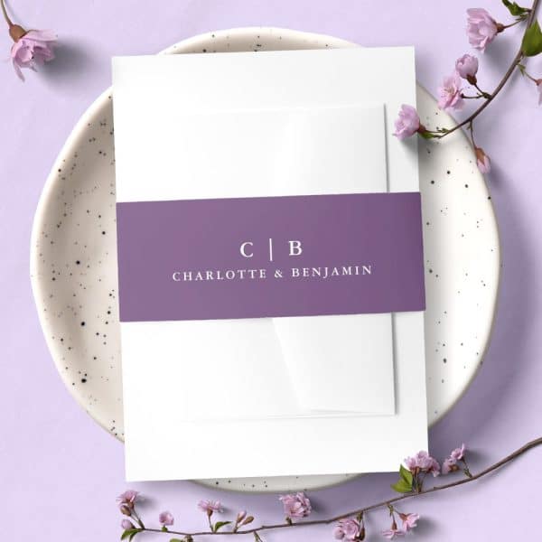 Wedding Invitation With A Purple Band Showing The Initials Cb And The Names Charlotte &Amp; Benjamin.