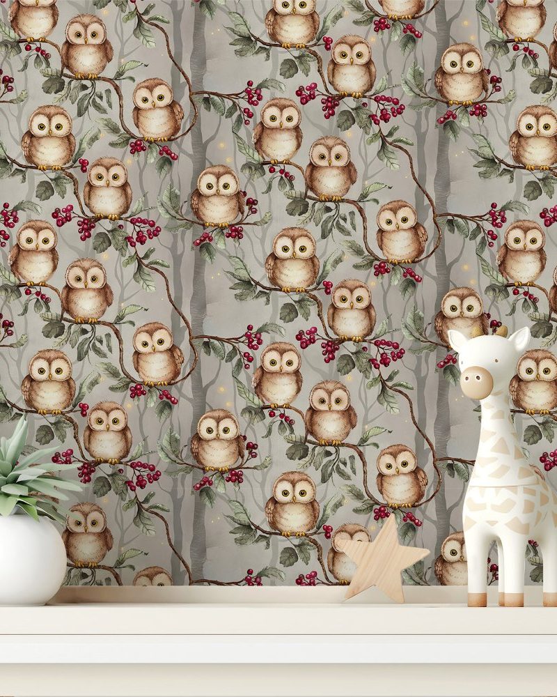 A gray owl-themed wallpaper featuring numerous owls perched on branches with red berries, displayed on a shelf with a small potted plant and a giraffe toy.