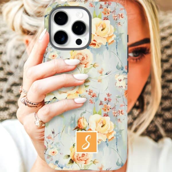 A Woman'S Hand Holds Up A Phone Case Featuring A Watercolor Floral Design With Yellow Roses And A Monogrammed Letter S.