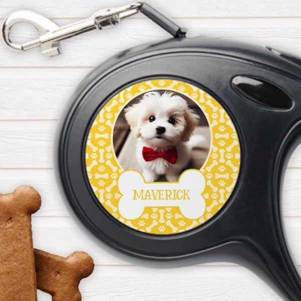 Retractable Dog Leash With A Yellow Bone-Shaped Design Featuring A Photo Of A Small White Dog Wearing A Red Bow Tie And The Name Maverick.