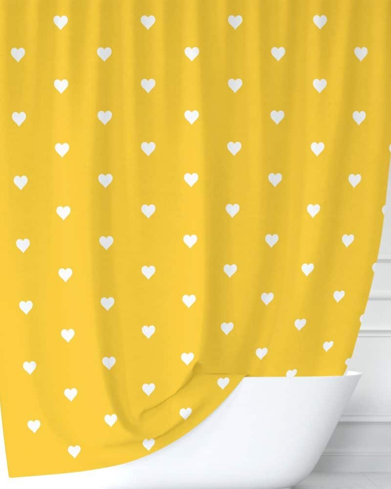 Mustard yellow shower curtain with a pattern of small white hearts.