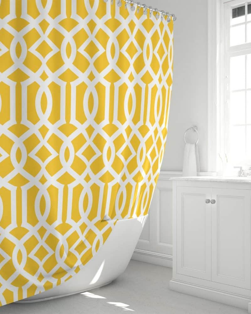 Mustard yellow shower curtain with a white geometric pattern.