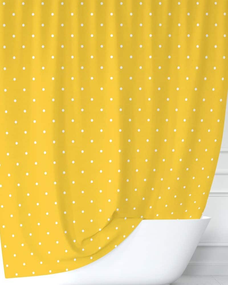 Yellow shower curtain with white polka dots.