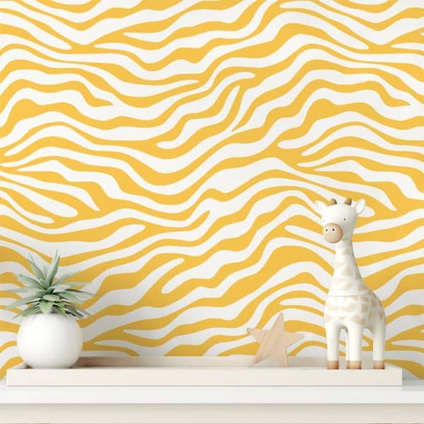 White And Yellow Zebra Striped Wall With A Small Giraffe Figurine And A Small Plant.