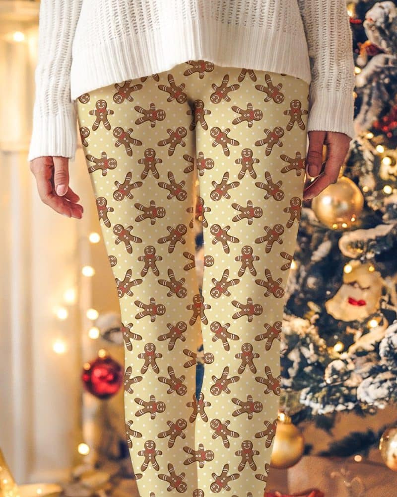 Beige leggings with a repeating pattern of gingerbread men.
