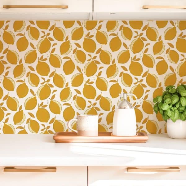 Kitchen Counter With A Mustard Yellow Lemon Pattern Backsplash, A Mug, And A Creamer.