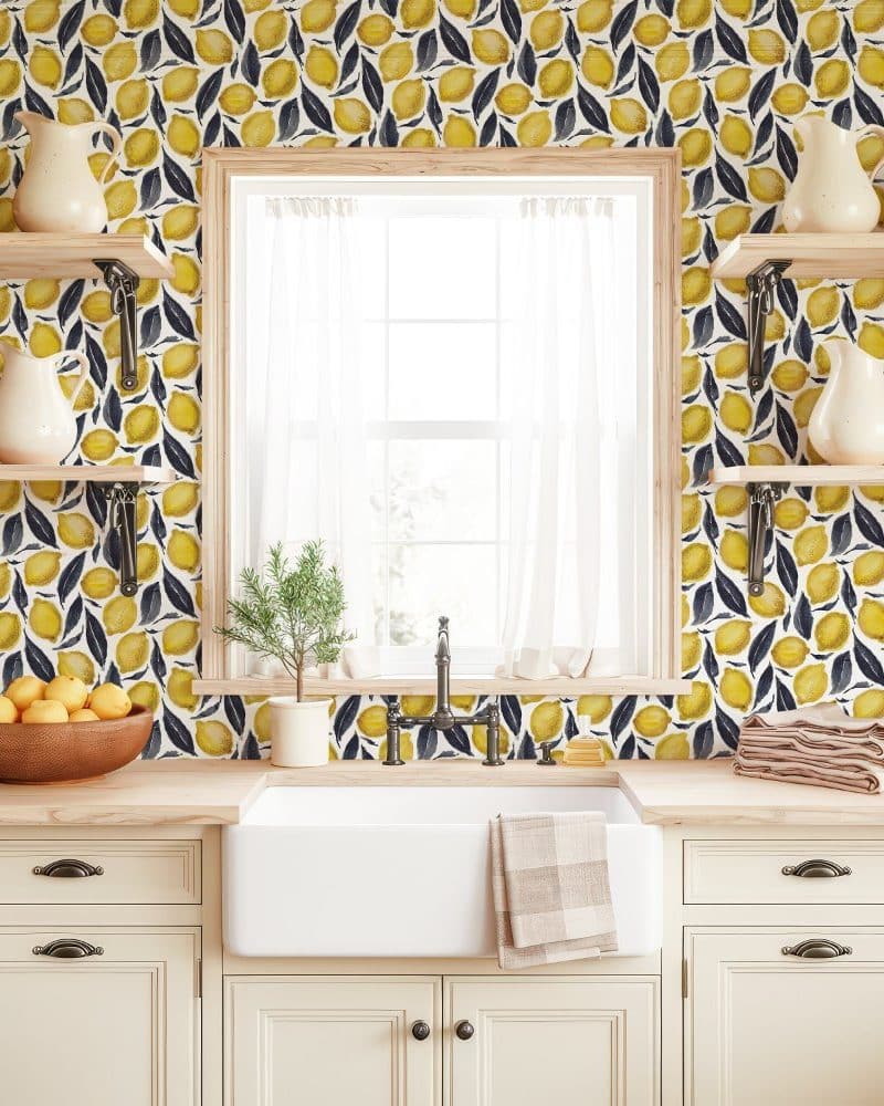 Kitchen backsplash with lemon and leaf pattern wallpaper.