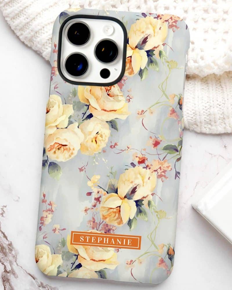 iPhone case with a pale blue floral design featuring yellow roses and the name Stephanie.