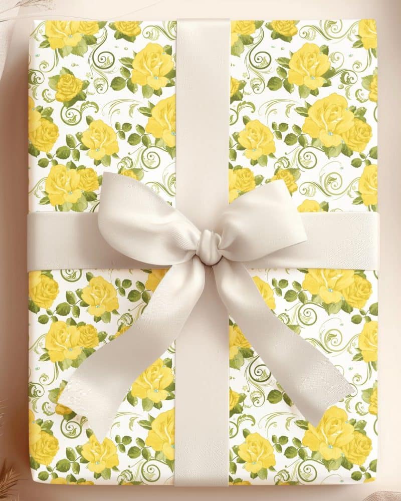 Gift box wrapped in yellow rose floral paper with a cream-colored ribbon.