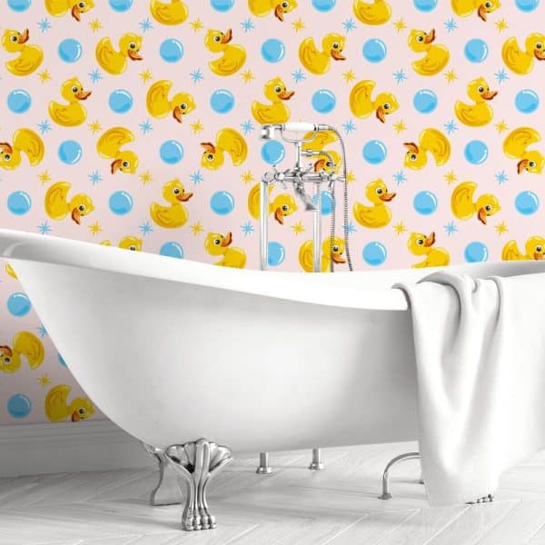 White Clawfoot Bathtub In A Bathroom With Pink Wallpaper Featuring Yellow Rubber Ducks And Blue Bubbles.