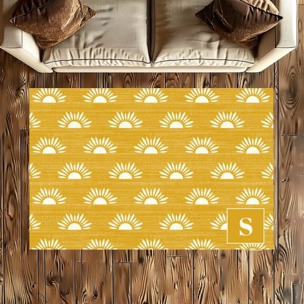 Mustard Yellow Rug With A Repeating Pattern Of White Suns And A Monogrammed S In The Bottom Right Corner.