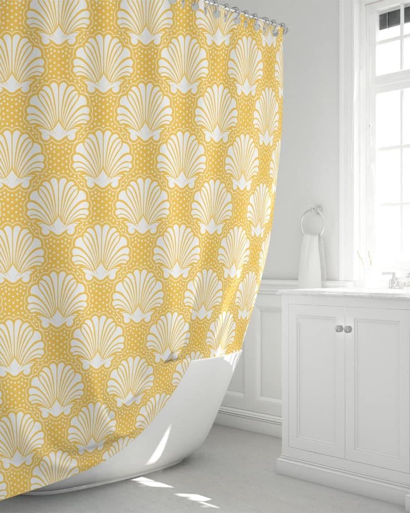 Mustard yellow shower curtain with a white seashell pattern.