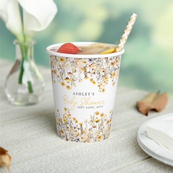A Floral Baby Shower Cup With Ashley'S Name And Date.
