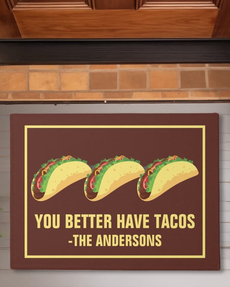 Brown doormat with three tacos and the text You Better Have Tacos -The Andersons.