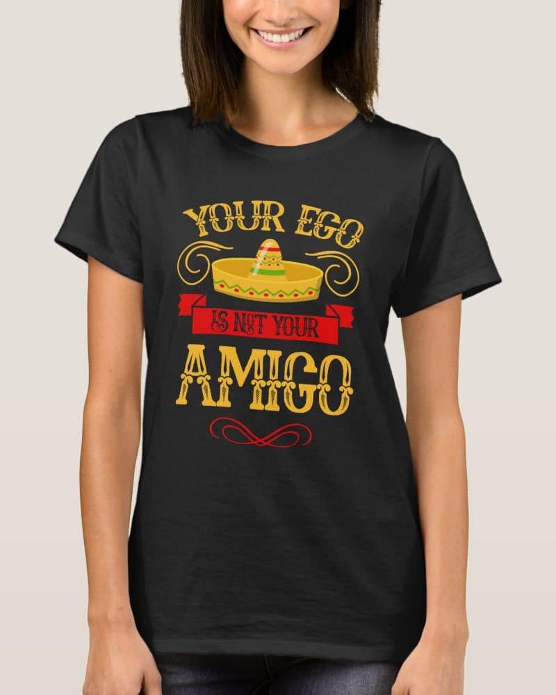 Woman wearing a black t-shirt with a sombrero graphic and text that reads Your Ego Is Not Your Amigo.